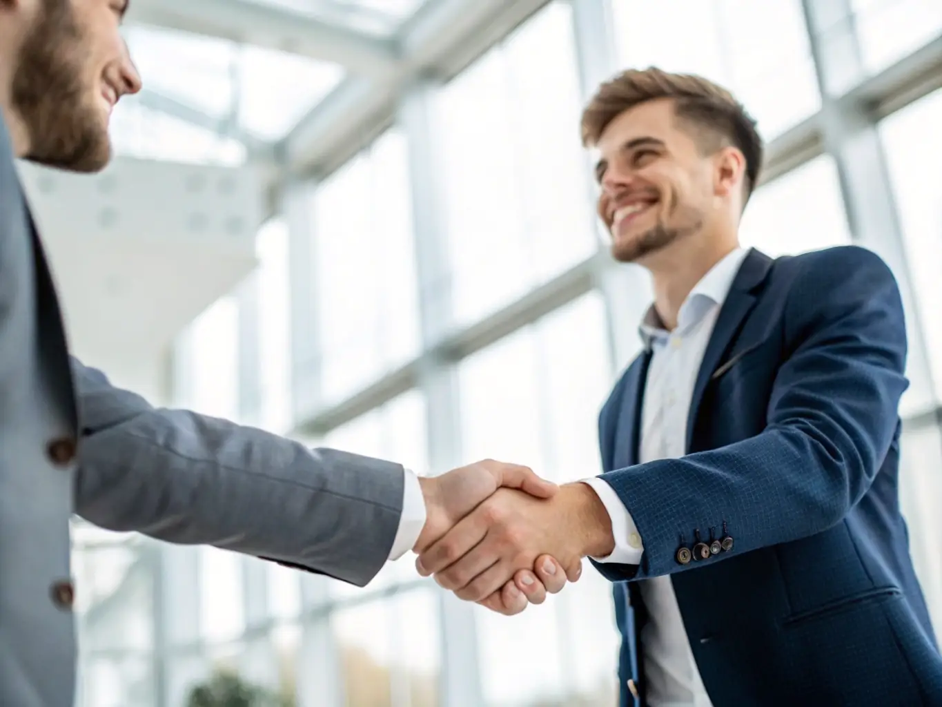A South African startup founder shaking hands with an investor, symbolizing GrowSpark's network and funding support.